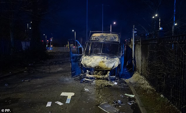 Protesters set a police van alight and chanted
