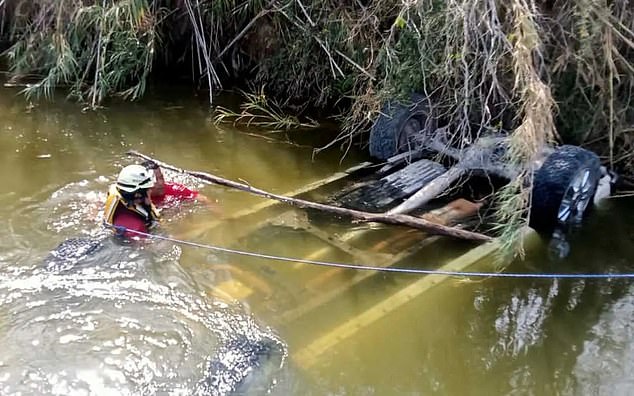 Authorities in the northern Mexican state of Nuevo León work to remove a pickup that plunged into a canal Tuesday and left 14 migrants dead. The group was reportedly headed to the Mexico-United States border