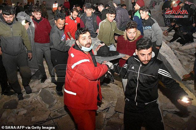 Rescuers are seen in the Syrian city of Hama trying to pull people from the rubble