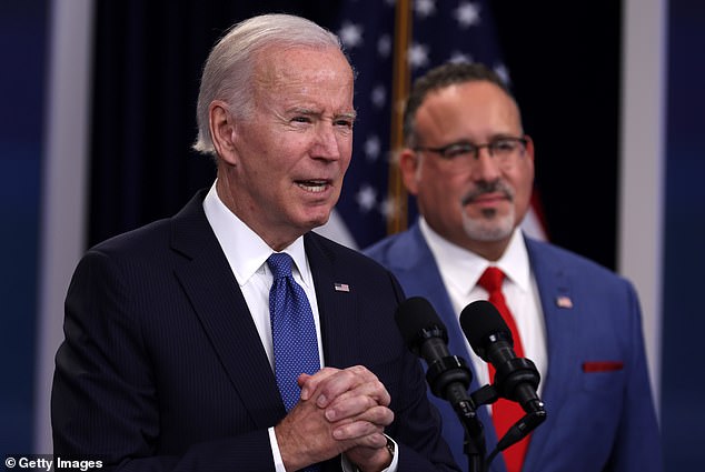 Biden (L) with Education Secretary Cardona (R) last October, who received the letter calling to