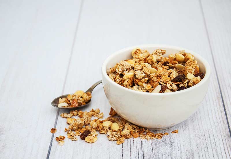 Bowl with granola on a old wooden table
