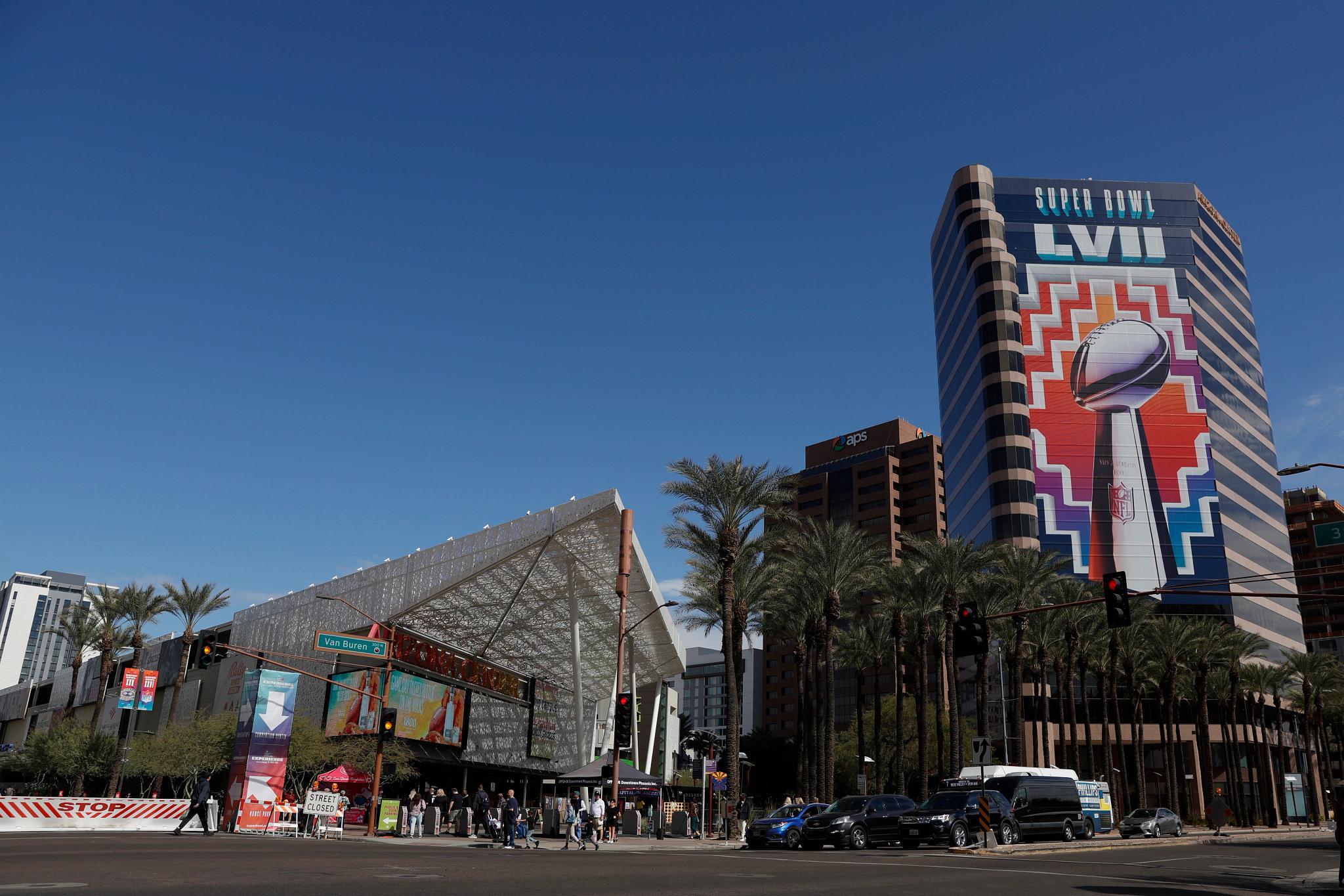 Fans walk around downtown Phoenix, outside of the fan experience, ahead of Super Bowl LVII on Feb. 11. (Getty Images)