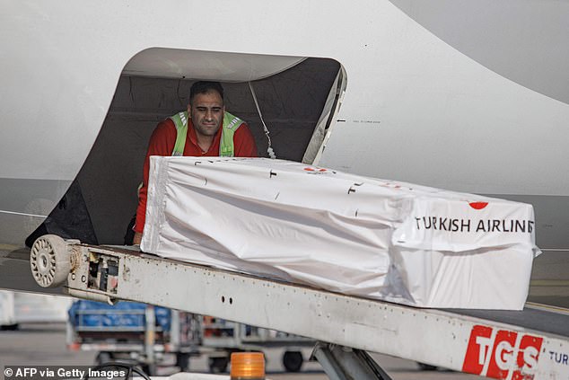 The coffin containing the body of former international football player Christian Atsu is loaded into an airplane bound for Ghana, at Adana airport in southern Turkey