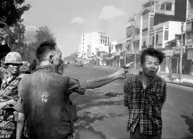 South Vietnamese Gen. Nguyen Ngoc Loan, chief of the National Police, fires his pistol into the head of suspected Viet Cong officer Nguyen Van Lem (also known as Bay Lop) on a Saigon street in February 1968, early in the Tet Offensive
