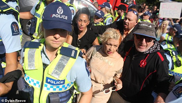 Controversial anti-trans activist Kelly-Jay Keen was doused with tomato juice at her Auckland rally on Saturday, forcing her to leave the protest early in the back of a police car and question whether to go forward with her upcoming rally in Wellington
