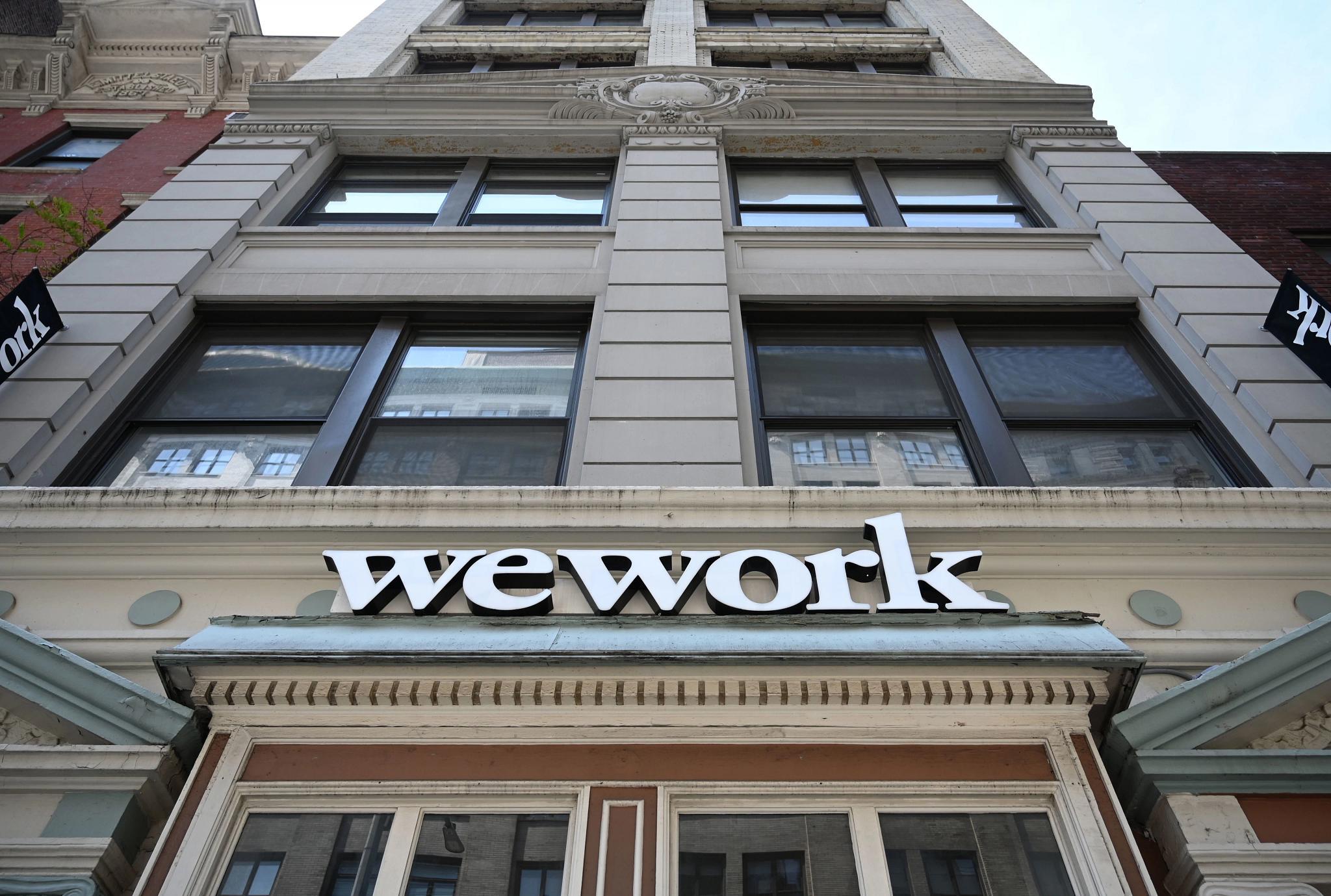 WeWork said it plans to "cure the deficiency." (Timothy A Clary/AFP via Getty Images)