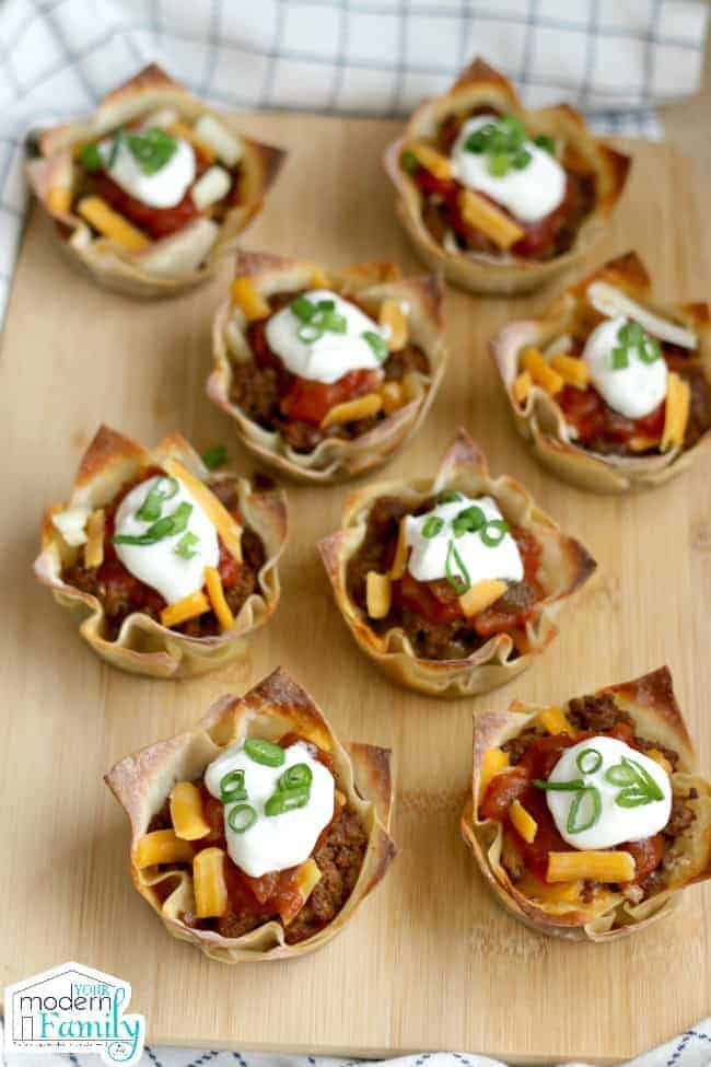 A plate filled with Taco and Cheese cups for a football party.